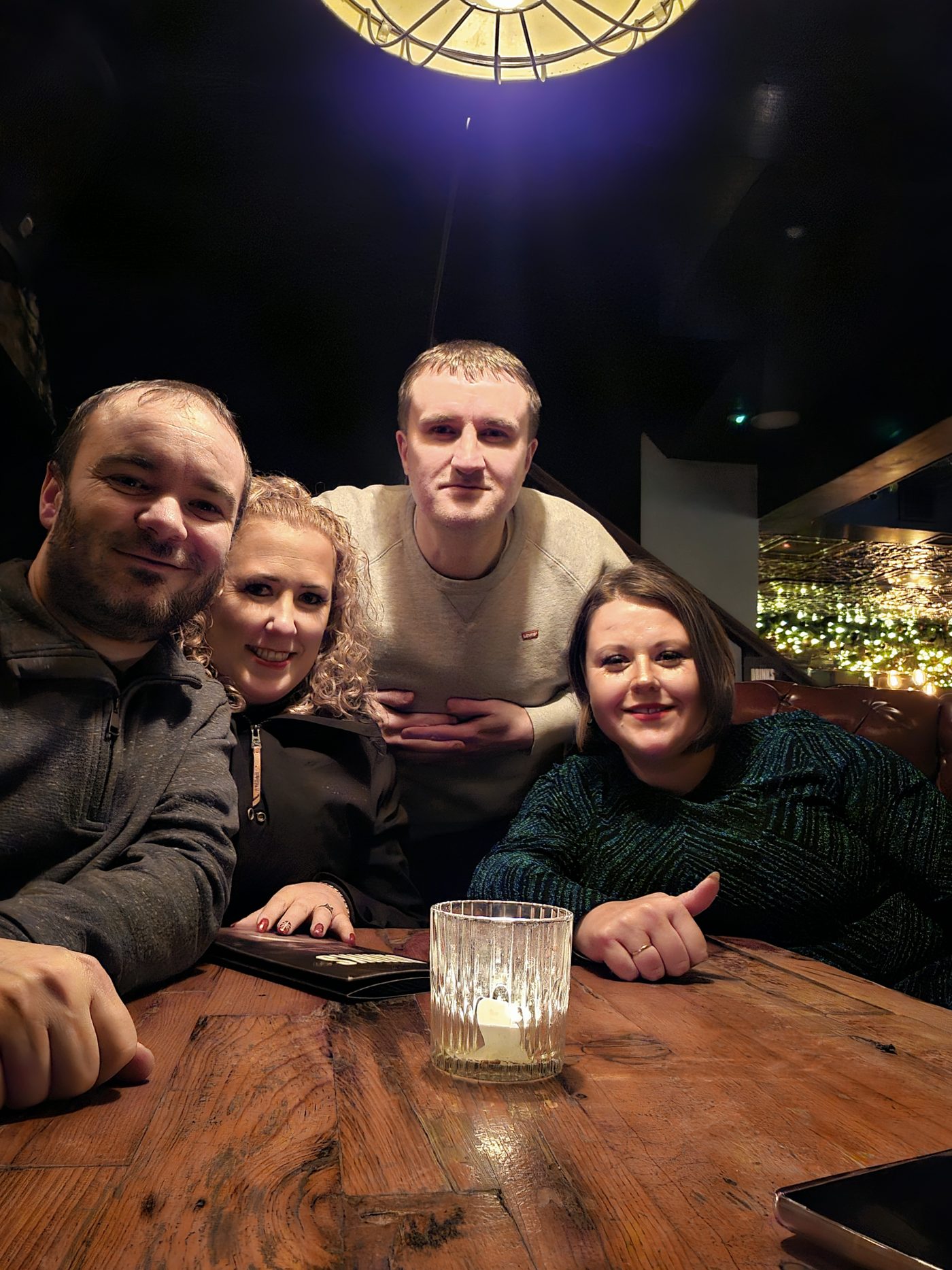 Candlelit table with Christmas tree behind, Chester December 2023