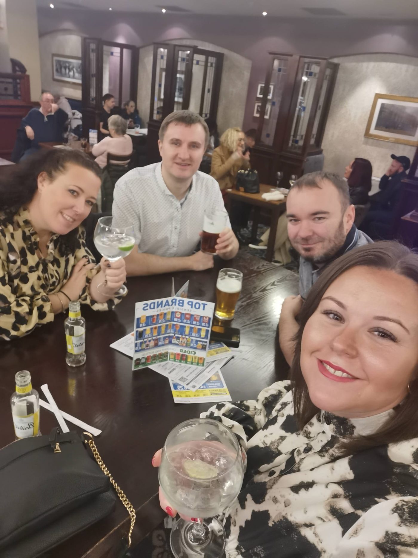 The four of us round a pub table with gins and pints, Manchester December 2021